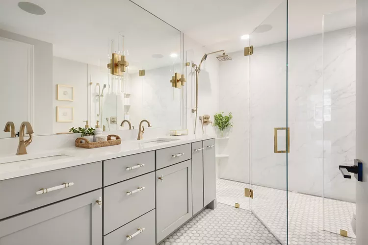 Interior-Impressions-Rivertown-Remodel-Stillwater-MN-Condo-Primary-Bathroom-Gray-Double-Vanity-Double-Walk-In-Shower-Gold-Hardware-dce9db4c70f54bca80276e582ec7c821